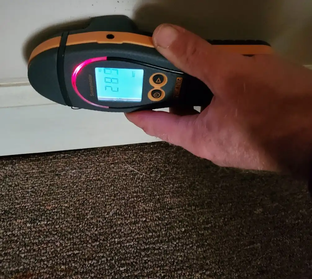 Moisture detection at baseboard during Storm Damage Restoration in Mount Zion